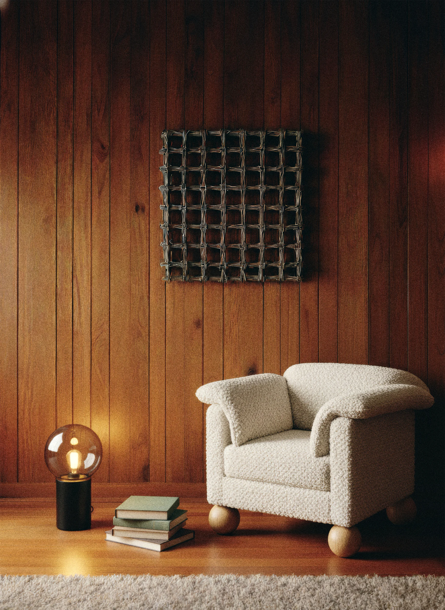 Уютная комната с белым креслом, деревянной обшивкой и книгами на полу.