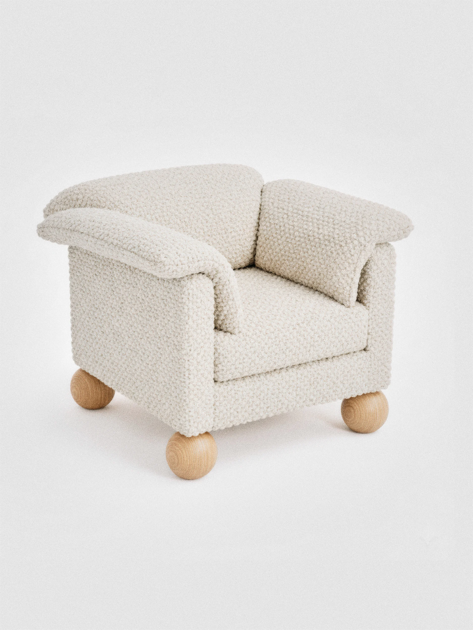 Кремовое кресло с светло-коричневыми ножками и текстурной тканевой обивкой.