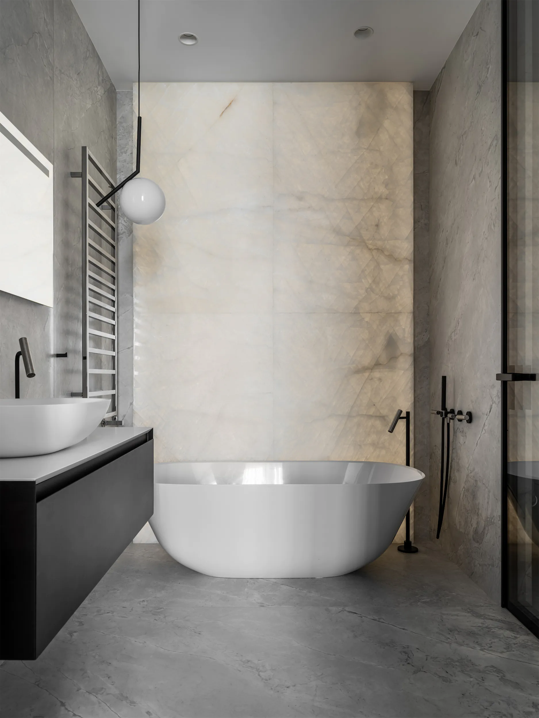 Современная ванная с белой ванной, чёрной сантехникой и серыми полом и стенами.